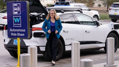 Phoenix Mayor Kate Gallego arrives in a self-driving vehicle, Friday, Dec. 16, 2022, at the Sky Harbor International Airport Sky Train facility in Phoenix.